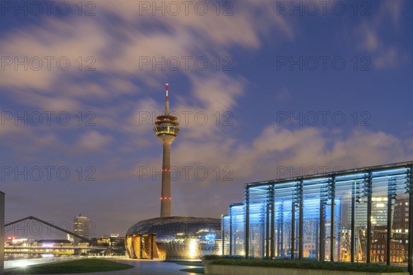 Terrace of the Hyatt Hotel and the Rhine Tower in Düsseldorf at dusk, North Rhine-Westphalia,