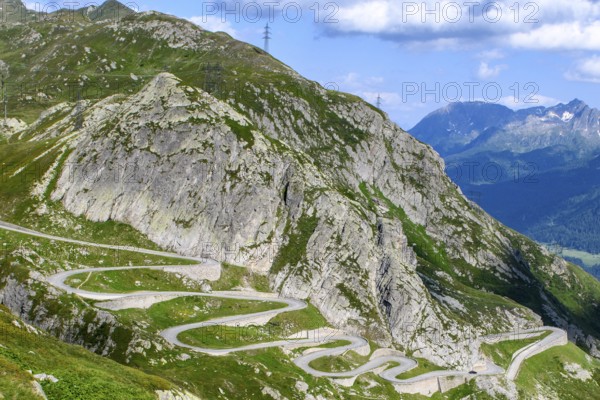Steep mountain slope in the Gotthard massif, in the foreground serpentines hairpin bends winding