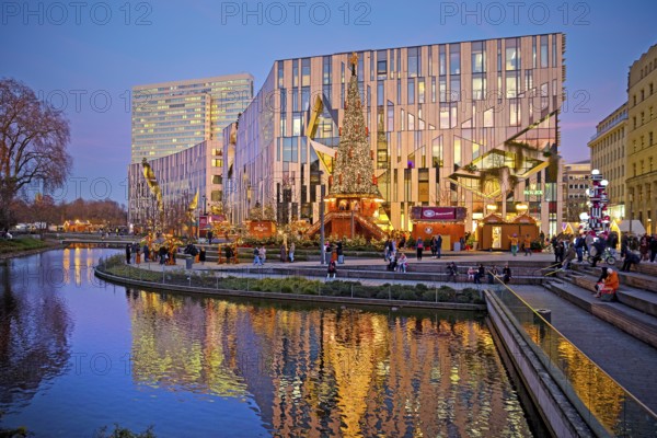 Dreischeibenhaus and Christmas market in front of the Koe-Bogen by architect Daniel Libeskind,
