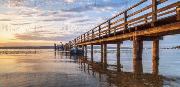 Morning atmosphere at the Lake Ammer, jetty in the first morning light, near Riederau, Bavaria,