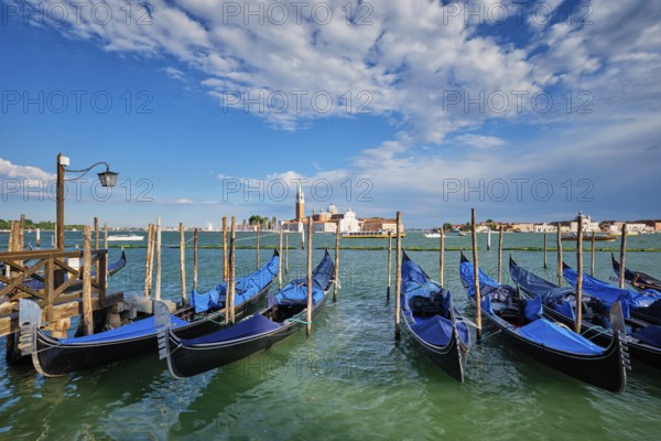 Gondolas and in lagoon of Venice by Saint Mark (San Marco) square with San Giorgio di Maggiore