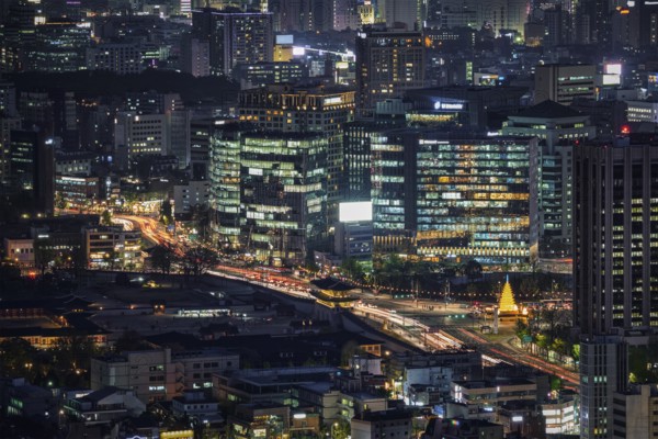 Seoul skyscrapers and Gyeongbokgung palace illuminated with lights view from Inwang mountain.
