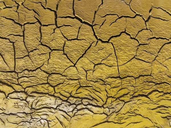 Mineral-rich cracked earth at the bank of the Rio Tinto (Red river), aerial view, drone shot,