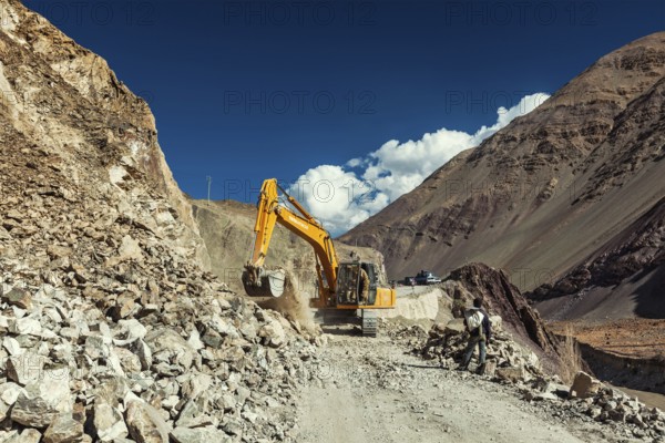 LADAKH, INDIA, SEPTEMBER 10, 2011: Excavator cleaning road after landslide in Himalayas. Ladakh,