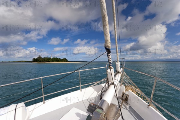 Sailing, sailing ship off uninhabited coral island Low Island near Port Douglas, Barrier reef,