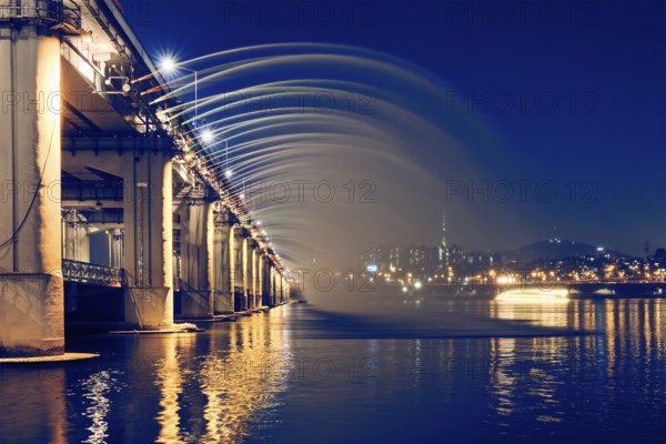 SEOUL, SOUTH KOREA, APRIL 7, 2017: Banpo Bridge Rainbow Fountain on Han river illuminated at night,
