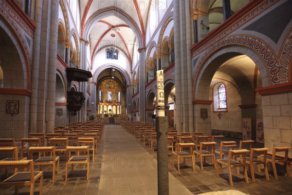 Interior view of the late Romanesque Church of the Assumption of Mary with pulpit and candle,