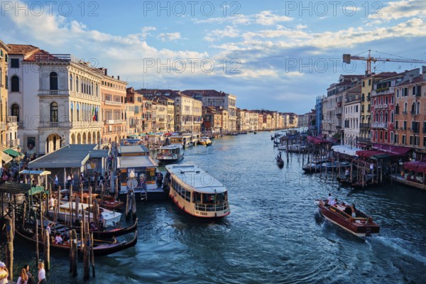 VENICE, ITALY, JUNE 27, 2018: Grand Canal with boats, vaporetto and gondolas on sunset from Rialto