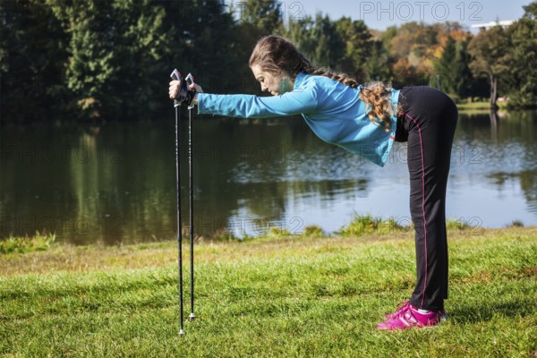 Nordic walking adventure and exercising concept, woman doing exercise with nordic walking poles in