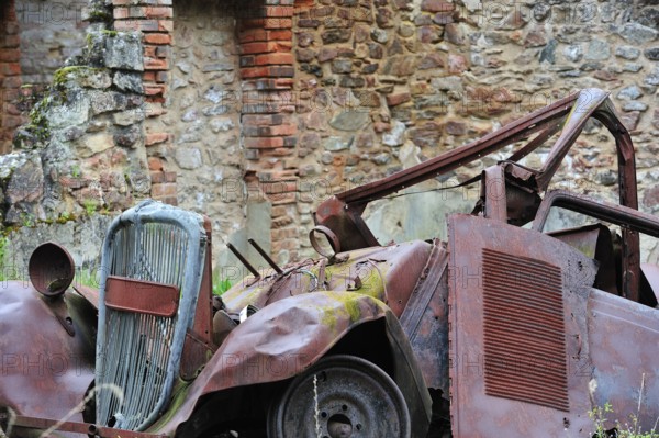 Burnt-out car in the garage. The burnt village of Oradour-sur-Glane was destroyed on 10 June 1944