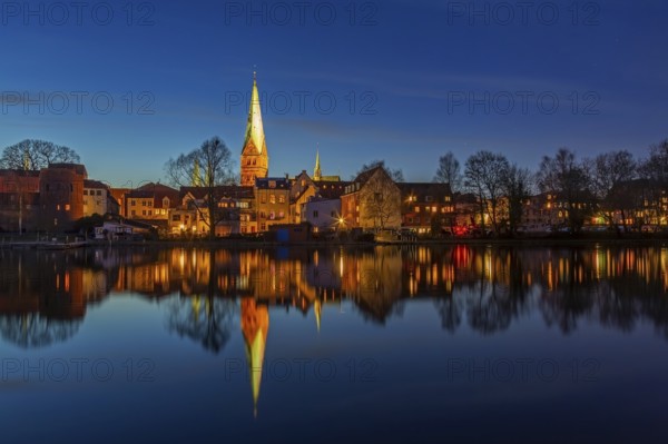Houses and St. -Aegidien-Kirche, Aegidienkirche reflected in water at Krähenteich in the old city