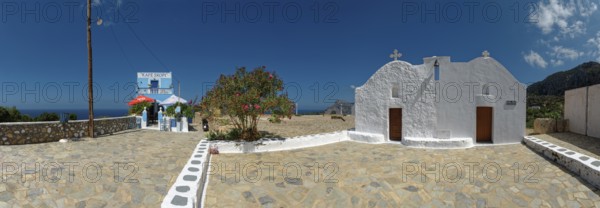 Café Skopi with small white church Parekkl?sia under a blue sky with a quiet Mediterranean