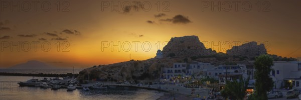 Harbour of the fishing village Finiki at dusk with boats and rocks, fishing village Finiki,