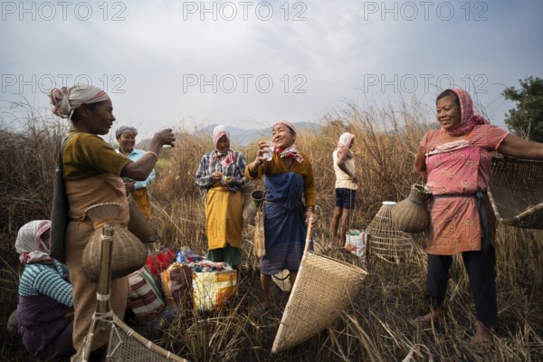 Villagers participate in a community fishing event on the occasion of the Bhogali Bihu festival at