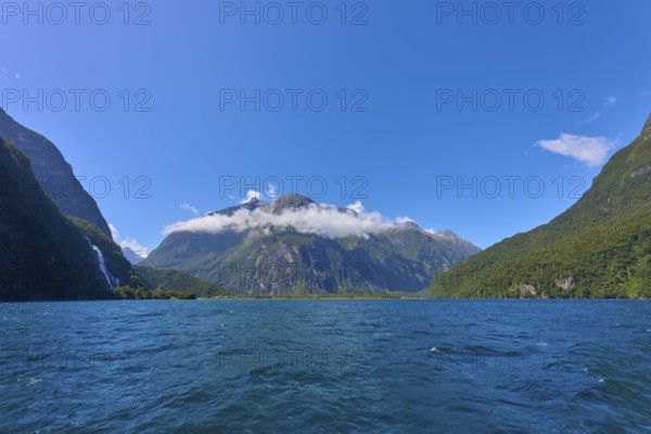 Majestic mountain landscape with clear fjord and light clouds under a sunny sky, summer, Milford