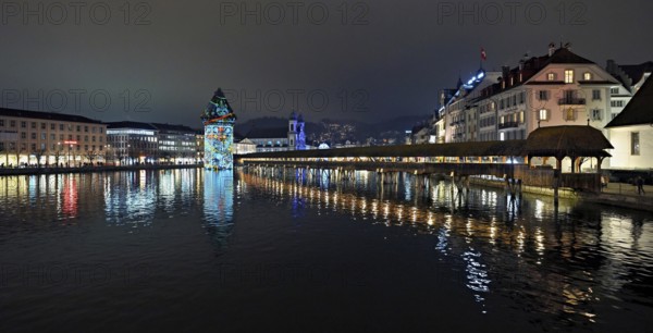 Wassertum with light installation, Chapel Bridge on the right, Jesuit Church on the Reuss at dusk