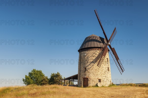 The tower windmill of Warnstedt in the evening light under a blue sky, Teufelsmühle, Thale,