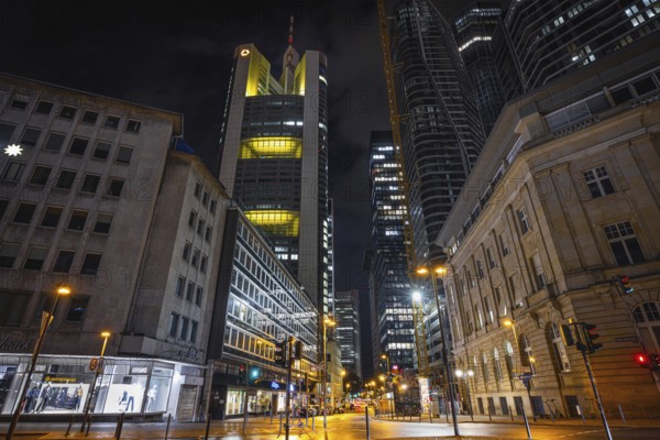 Clouds pass over the shining Commerzbank Tower in the dark evening sky, Rossmarkt, Frankfurt am