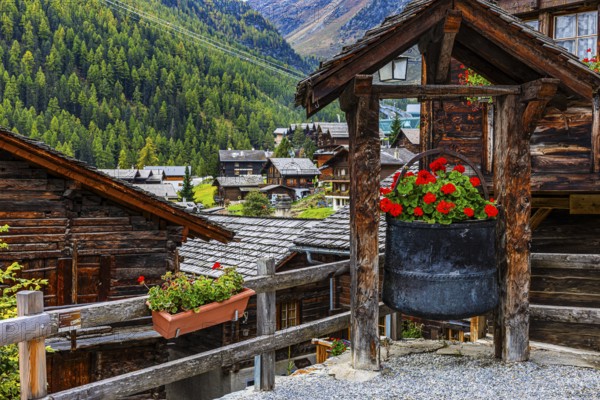 Old copper kettle decorated with flowers in the historic village centre, Grimentz, Val d'Anniviers,