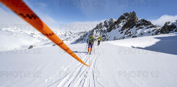 Ski tourer with rope, rope team on the Vadret da Porchabella glacier on the ascent to the summit of