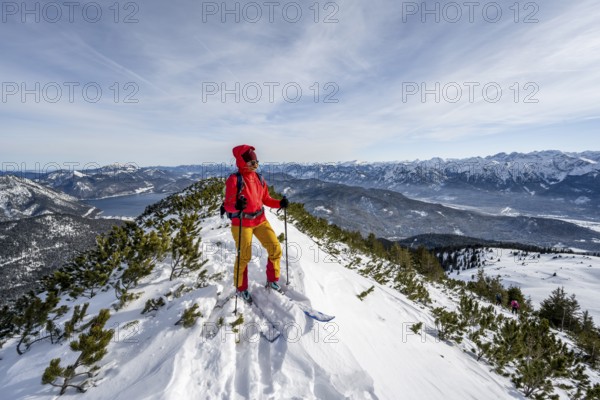 Ski tourer at the summit of Simetsberg, mountain panorama, Estergebirge, Bavarian Prealps, Bavaria