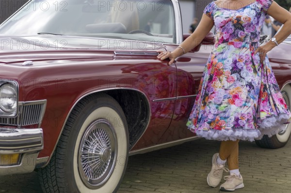 Vintage American road cruiser Buick with woman and petticoat