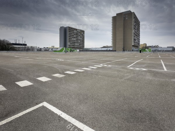 Symbolic image economic crisis, dark clouds in the sky, empty parking deck at