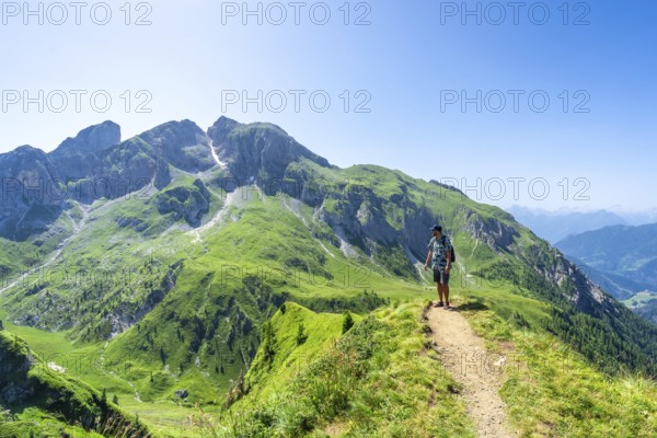 Tourist enjoying breathtaking scenery while hiking on the giau pass, surrounded by the stunning