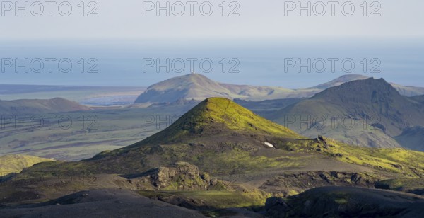 Volcanic mountain landscape overgrown with moss, atmospheric mountain landscape in the evening