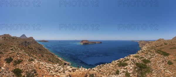Hikers on the way to the cape of the Gramvousa peninsula with a view of the island of Imeri