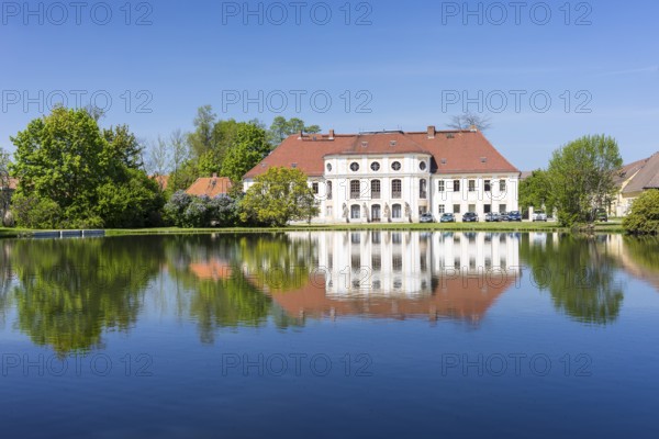 Baroque castle with reflection in the large pond, Königswartha, Upper Lusatia, Saxony, Germany,
