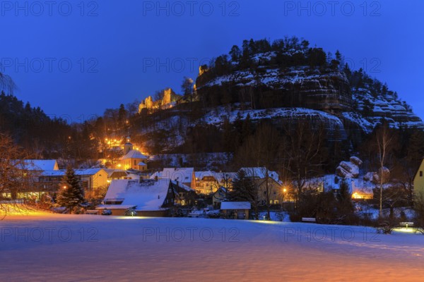View of Oybin Mountain with ruins and village with mountain church in the snow, Oybin, Zittau
