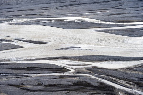 Detail, structure, river course in a gravel bed with black sand, meandering river, Dímonarhellir,