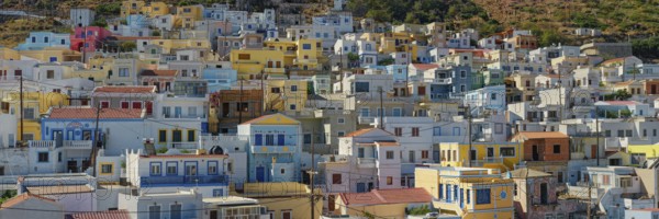 Panorama of the village of Menetes with densely built pastel-coloured houses on a Mediterranean
