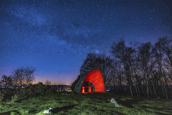 Milky way in the beautiful illuminated hermitage of Agiña, Navarra