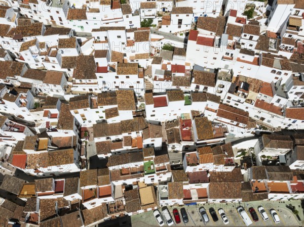 The brilliant White Town of Casares clings to a steep hillside. Aerial view. Drone shot. Málaga