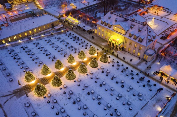 Aerial view of Wackerbarth Castle with castle park in snow and Christmas lights, Radebeul, Saxony,
