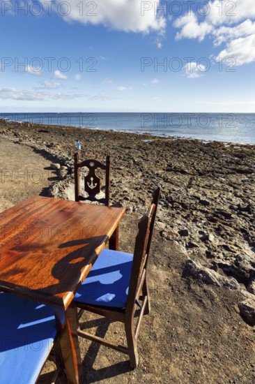 Wooden table and chairs, fish restaurant on the beach, Playa Quemada, Yaiza, Lanzarote, Spain,
