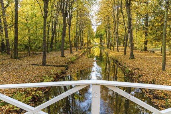 Bridge over the castle moat in autumn, park of Hermsdorf Castle, Ottendorf-Ockrilla, Saxony,