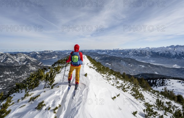 Ski tourer at the summit of Simetsberg, mountain panorama, Estergebirge, Bavarian Prealps, Bavaria