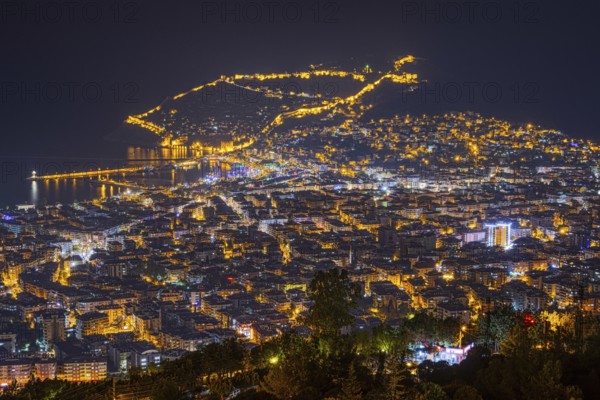 The lights of the city of Alanya on the Turkish Riviera glow in the evening, Alanya, Antalya,