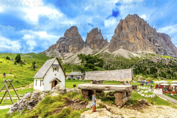 Breathtaking summer view of the majestic sassolungo mountain at sella pass, featuring a wooden