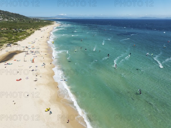 Kite surfers at the Valdevaqueros beach near Tarifa. In the distance the coastline of Morocco.