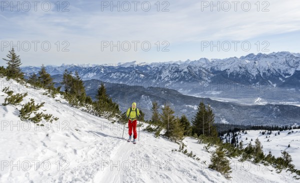 Ski tourers climbing Simetsberg, view of mountain panorama, Estergebirge, Bavarian Prealps, Bavaria