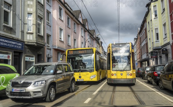 Tram and bus in traffic, on the street Schonnebeckhöfe in Essen-Katernberg, North Rhine-Westphalia,