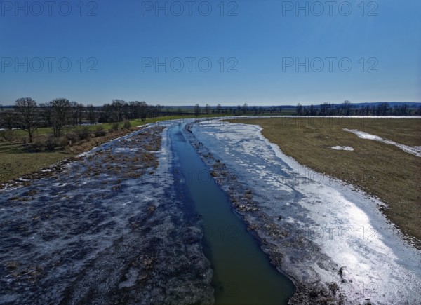 Icy drainage ditch in the landscape of the Havel floodplain in the Altmark. Aerial view. Havelberg,