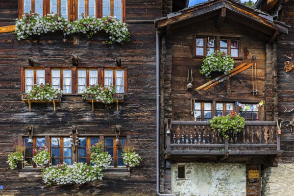 Wooden houses decorated with flowers in the historic village centre, Grimentz, Val d'Anniviers,