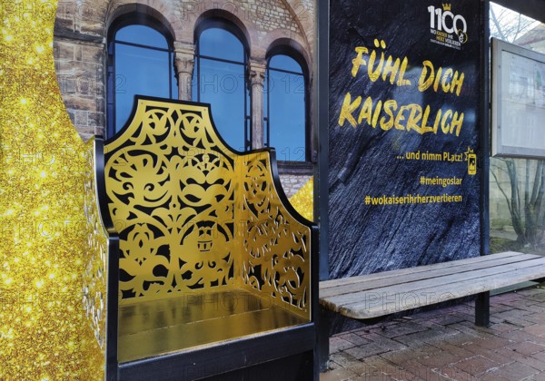 Bus stop in the old town centre with golden Kaiserstuhl and the words Fühl Dich Kaiserlich, Goslar,