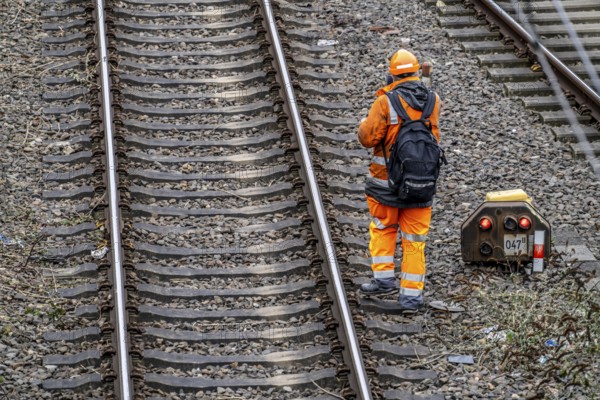 Worker on the railway tracks, after the end of his shift, walking home from the tracks, North