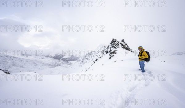 Ski tourers in a wintry mountain landscape in fresh snow, Ortler Alps, Vinschgau Valley, Italy,